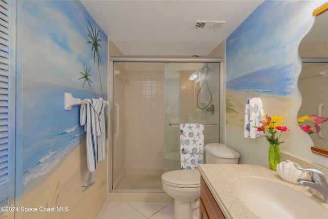 bathroom with tile patterned flooring, vanity, a shower with shower door, and toilet