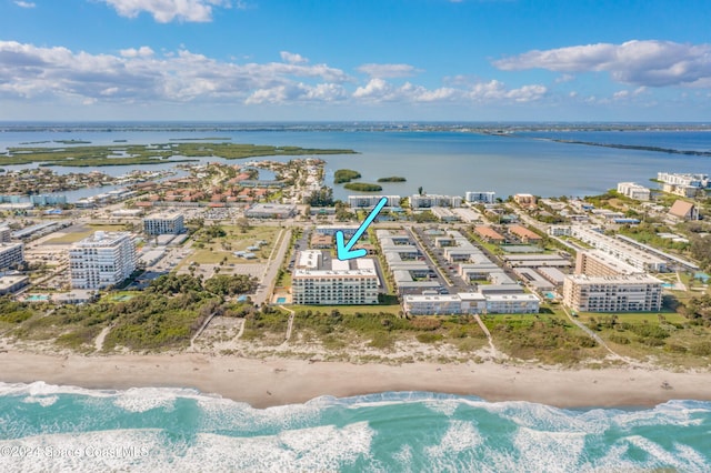 drone / aerial view with a water view and a beach view