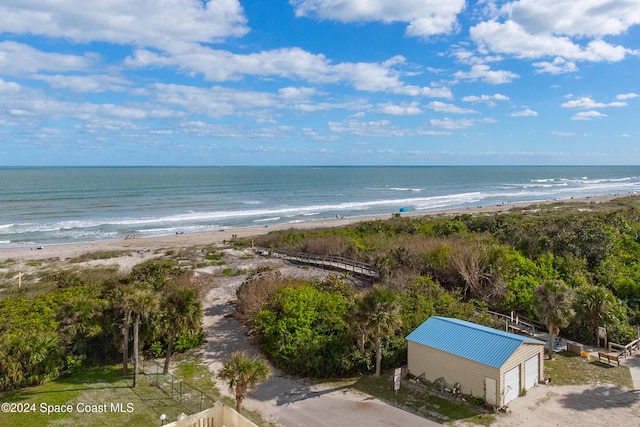 property view of water featuring fence and a view of the beach