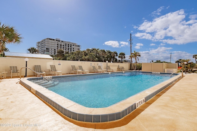 view of swimming pool featuring a patio