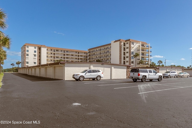 view of building exterior with uncovered parking