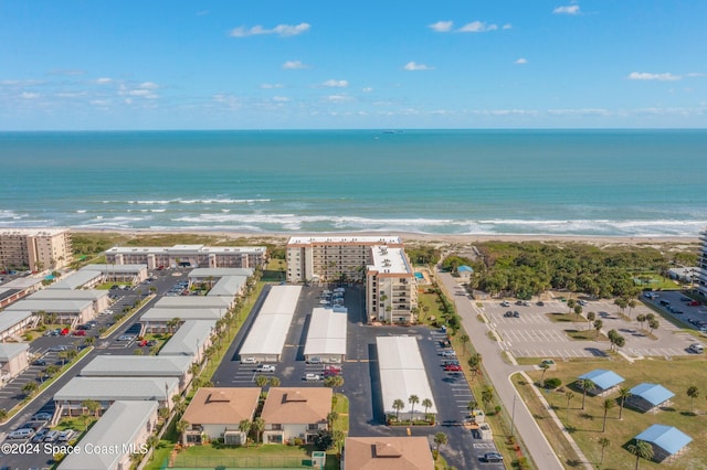 birds eye view of property with a water view and a view of the beach