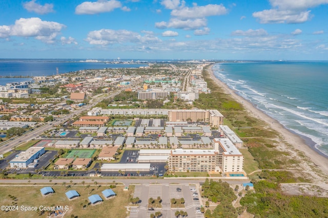 drone / aerial view with a beach view and a water view