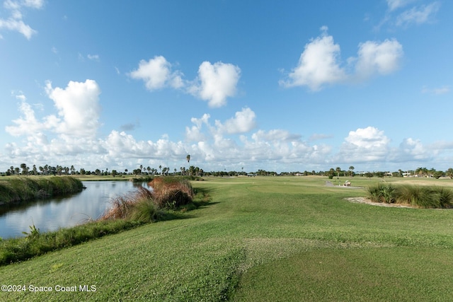 surrounding community with a yard and a water view