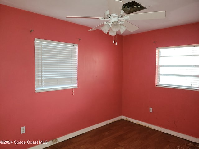 unfurnished room with dark hardwood / wood-style floors and ceiling fan