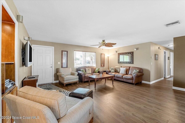 living room featuring dark hardwood / wood-style flooring and ceiling fan