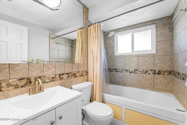 full bathroom featuring a textured ceiling, toilet, shower / tub combo with curtain, vanity, and tile walls