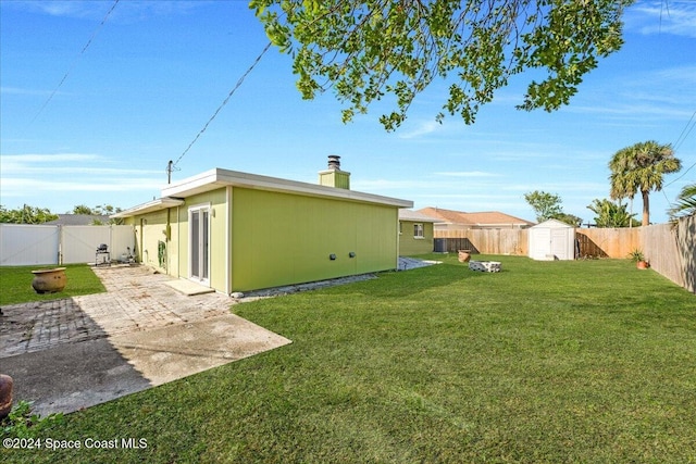 view of yard with a patio area and a storage shed