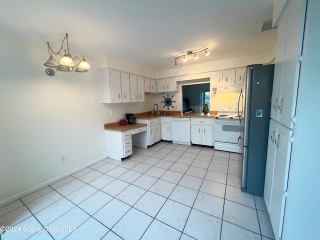 kitchen with white cabinets, white appliances, hanging light fixtures, and a notable chandelier