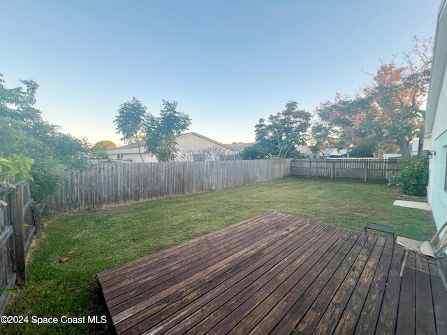 wooden terrace with a lawn