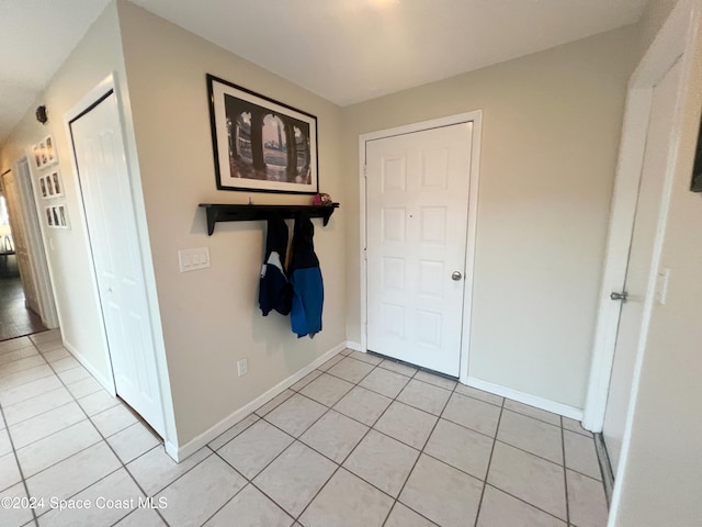 foyer entrance with light tile patterned flooring