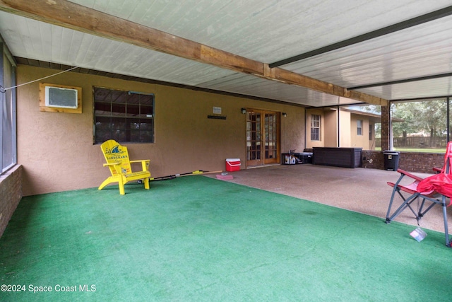 interior space featuring beam ceiling and a wall mounted air conditioner