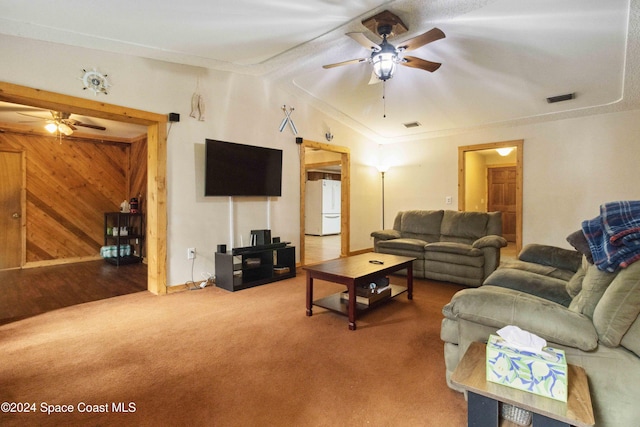 living room with carpet, ceiling fan, crown molding, and vaulted ceiling