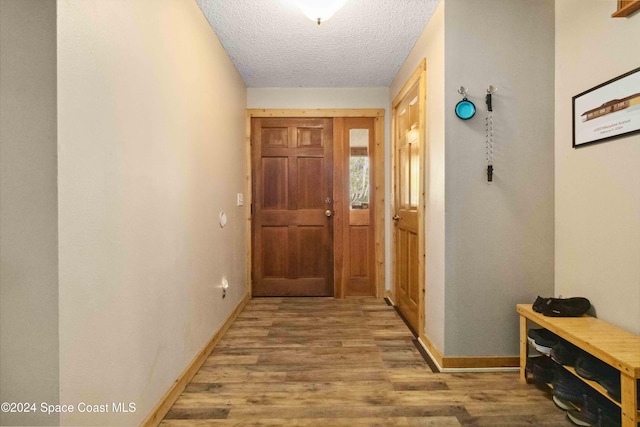 entryway featuring a textured ceiling and hardwood / wood-style flooring