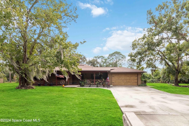 view of front of house featuring a garage and a front lawn