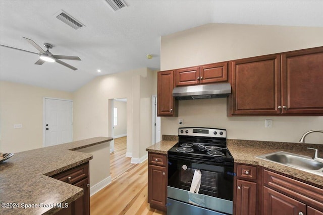 kitchen featuring stainless steel electric range, sink, vaulted ceiling, ceiling fan, and light hardwood / wood-style floors