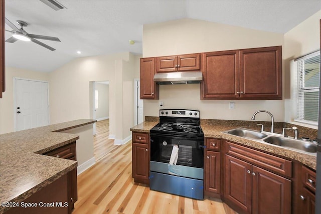 kitchen with vaulted ceiling, ceiling fan, sink, light hardwood / wood-style flooring, and stainless steel range with electric cooktop