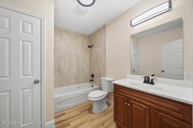 full bathroom featuring vanity, toilet, tiled shower / bath, and hardwood / wood-style flooring