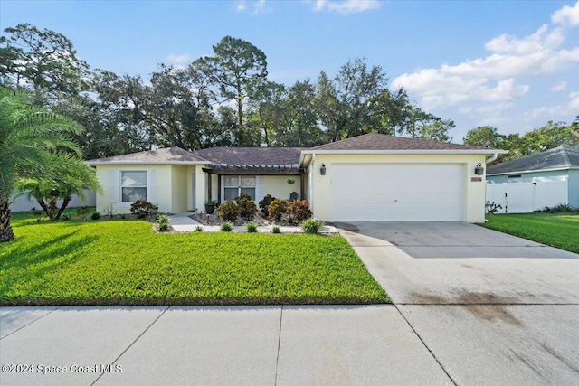 ranch-style house with a garage and a front lawn