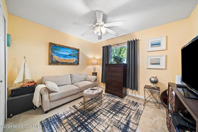 carpeted living room with ceiling fan and a textured ceiling