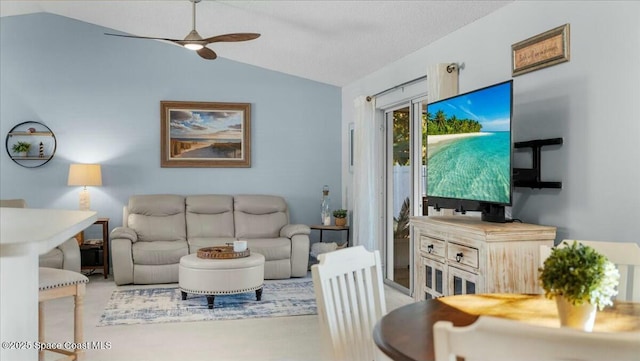 living room featuring ceiling fan and vaulted ceiling