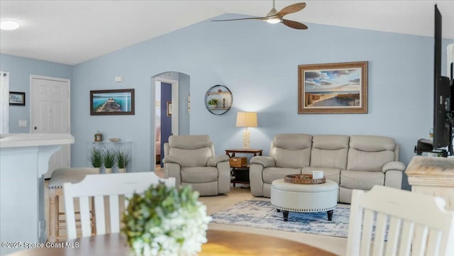 living room featuring ceiling fan and vaulted ceiling