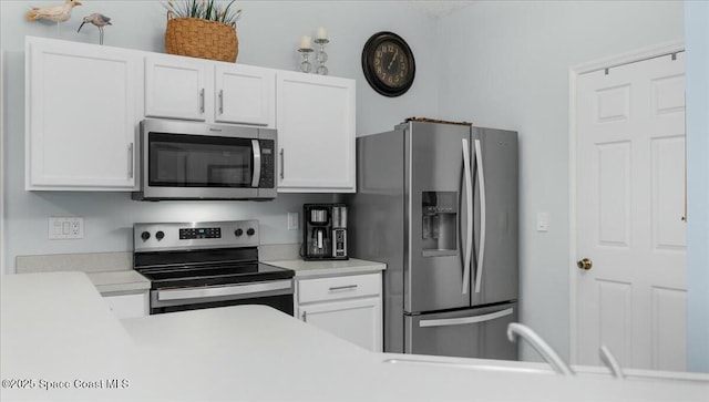 kitchen with white cabinets and stainless steel appliances