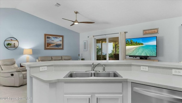 kitchen with dishwasher, white cabinetry, sink, and lofted ceiling