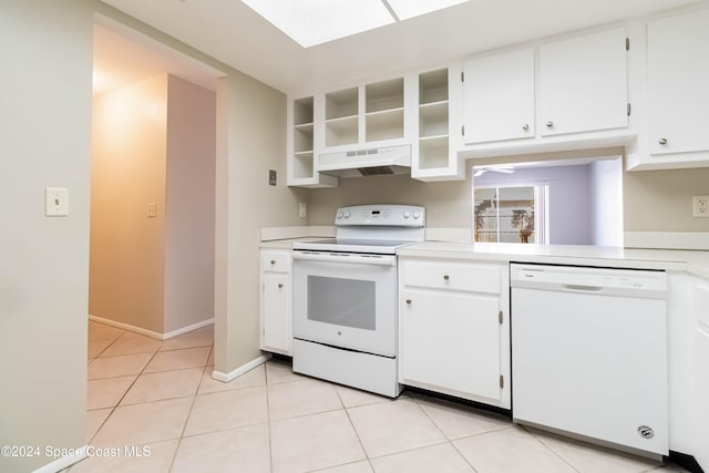 kitchen featuring white cabinetry, light tile patterned flooring, and white appliances