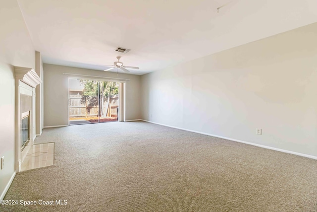 carpeted empty room featuring ceiling fan