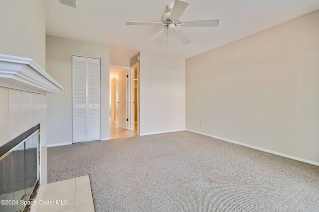 unfurnished living room featuring light colored carpet and ceiling fan