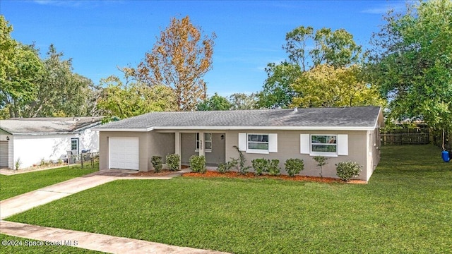 ranch-style home with a front yard and a garage