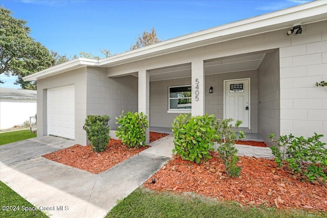 view of exterior entry featuring a garage