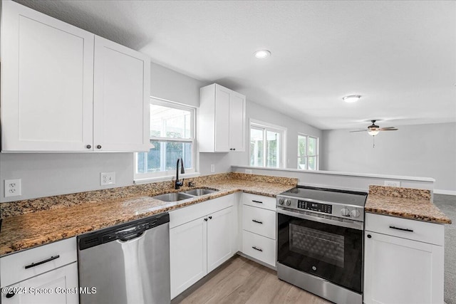 kitchen with white cabinets, appliances with stainless steel finishes, a healthy amount of sunlight, and sink