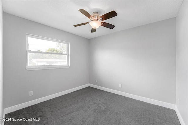 carpeted spare room featuring ceiling fan and a textured ceiling