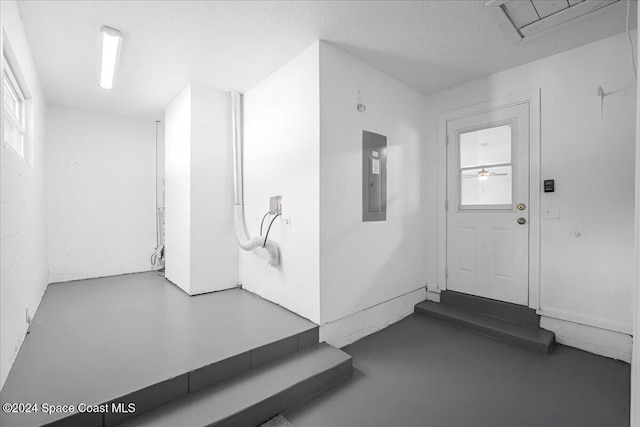 entryway featuring electric panel, ceiling fan, and a textured ceiling