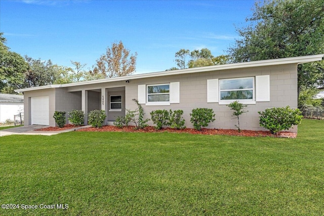 ranch-style home featuring a front yard and a garage