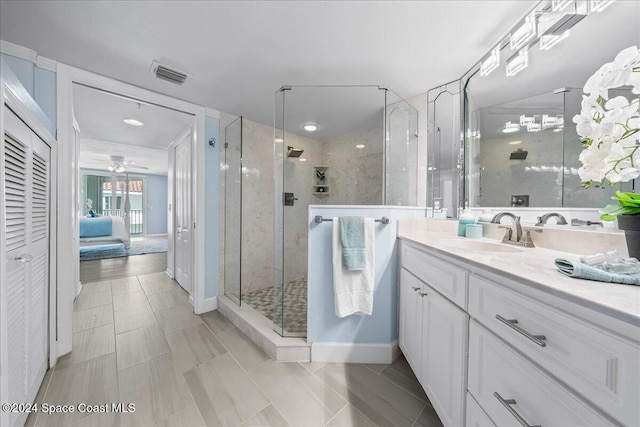 bathroom featuring ceiling fan, tile patterned flooring, vanity, and a shower with shower door