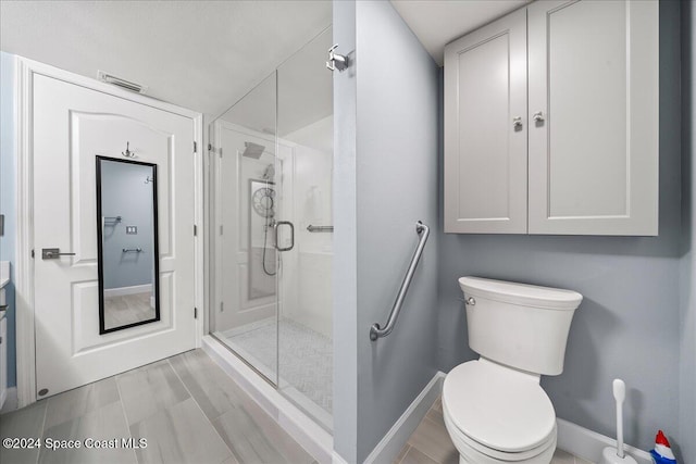 bathroom featuring toilet and walk in shower