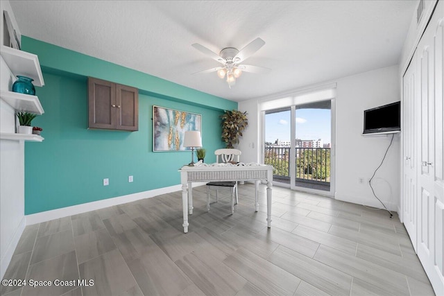 office space with ceiling fan and light hardwood / wood-style floors