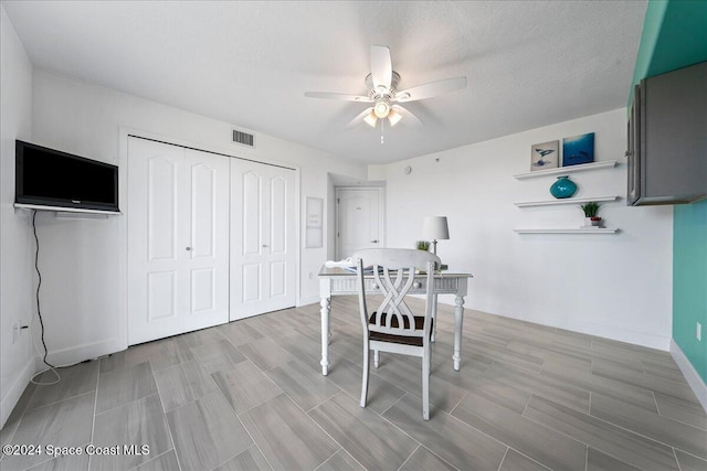 dining area featuring a textured ceiling and ceiling fan