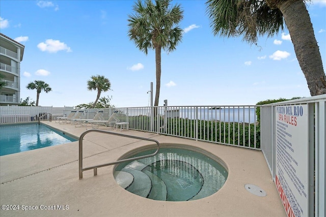 view of pool featuring a patio area and a community hot tub