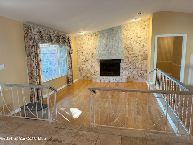 unfurnished living room featuring a fireplace and hardwood / wood-style flooring