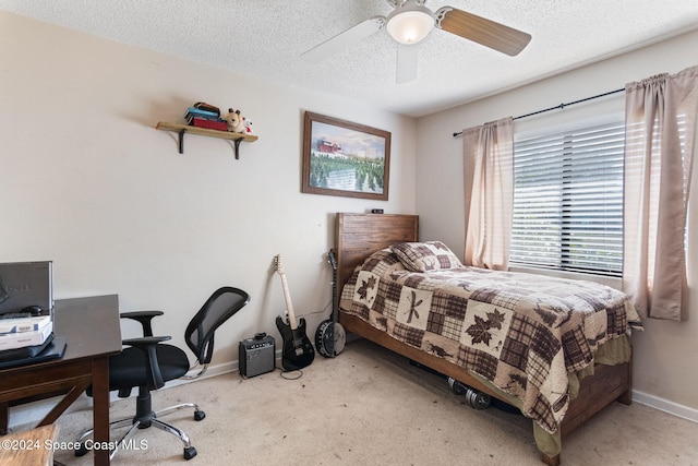 bedroom with carpet flooring, ceiling fan, and a textured ceiling