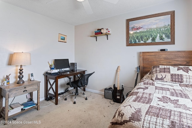 carpeted bedroom with ceiling fan and a textured ceiling