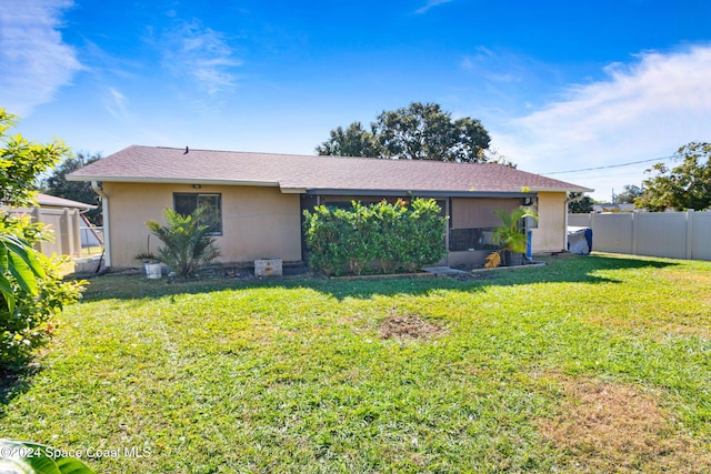 rear view of property with a lawn