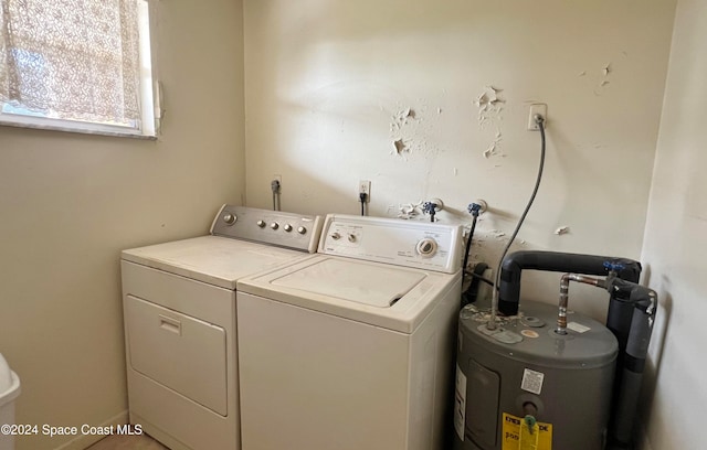 laundry room featuring water heater and washer and clothes dryer