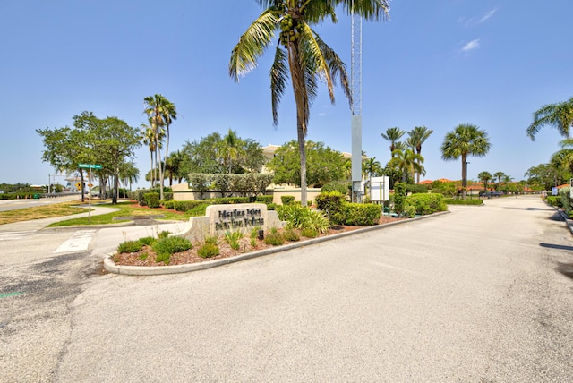 view of asphalt road with curbs