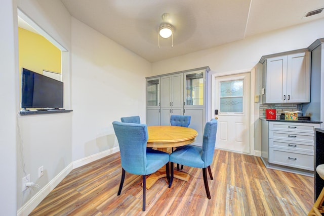 dining room with light wood finished floors and baseboards