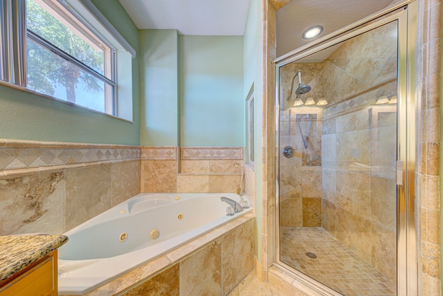 bathroom with vanity and independent shower and bath